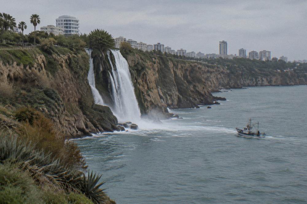 Water falling from a cliff directly into the sea