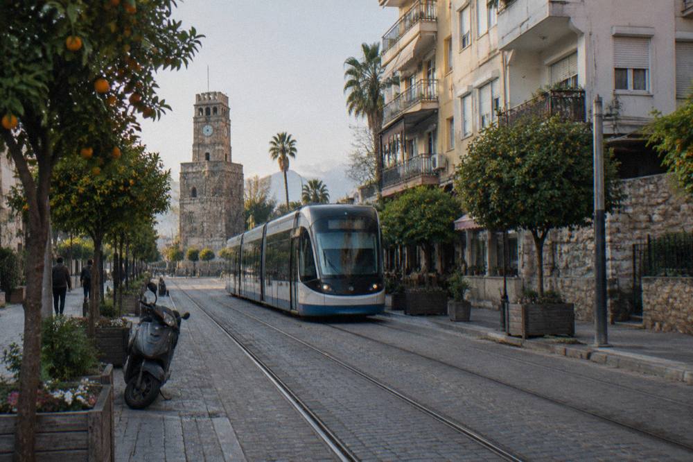 A modern tram travelling along a street in central Antalya