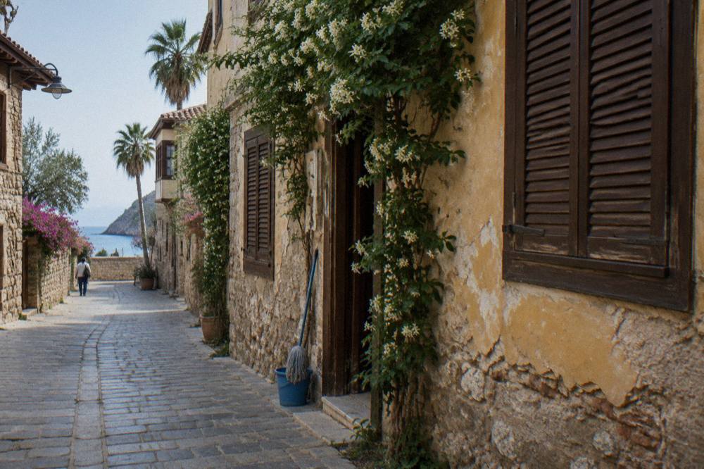 A narrow old town street with stone houses and wooden shutters in Kaleici