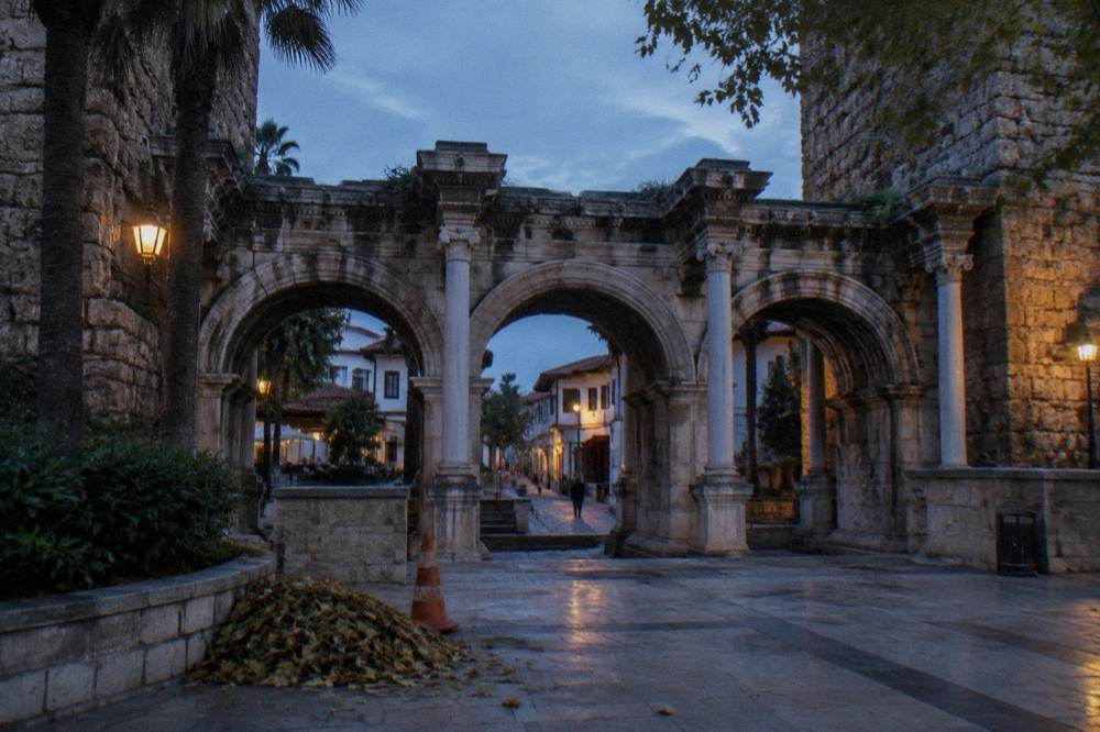 Hadrian's Gate stone arches on a Kaleici street with the old town lanes beyond