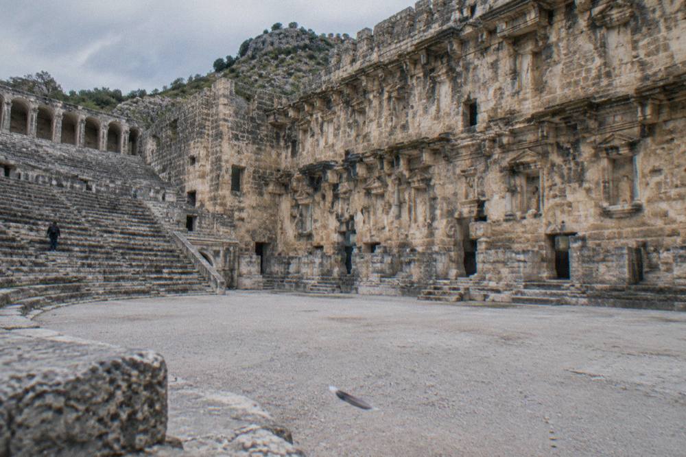 The stone stage wall of the Aspendos theatre rising above the empty orchestra