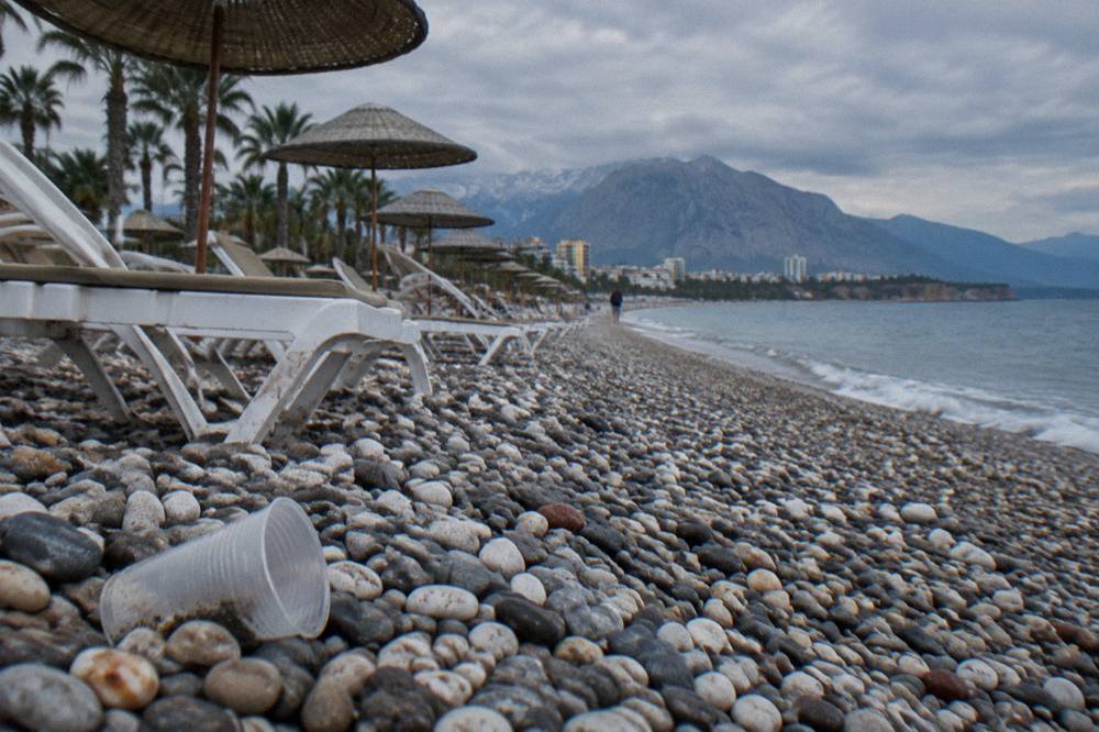The Konyaalti shore with empty sun loungers in rows facing the sea