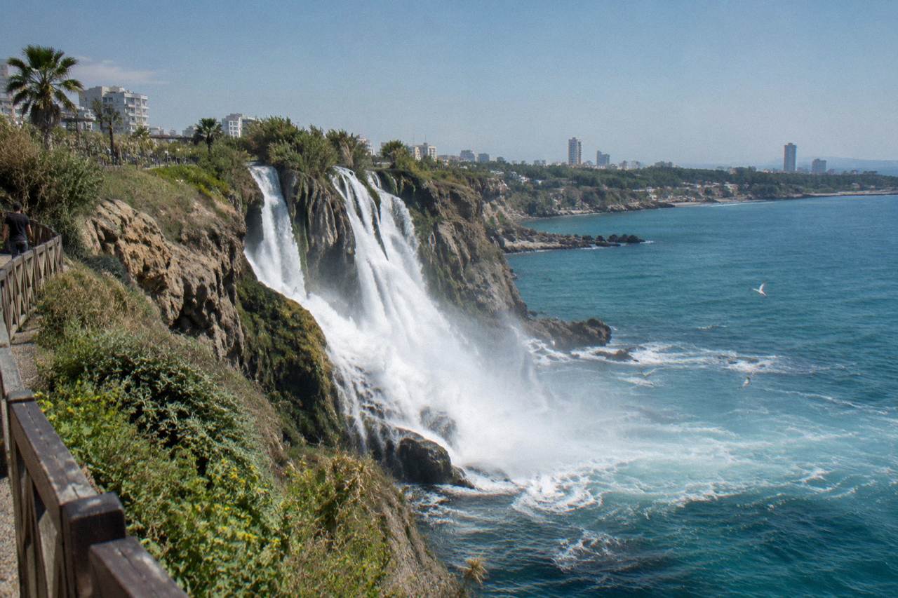 The Lower Duden Waterfall falling from the cliff into the sea below the park path