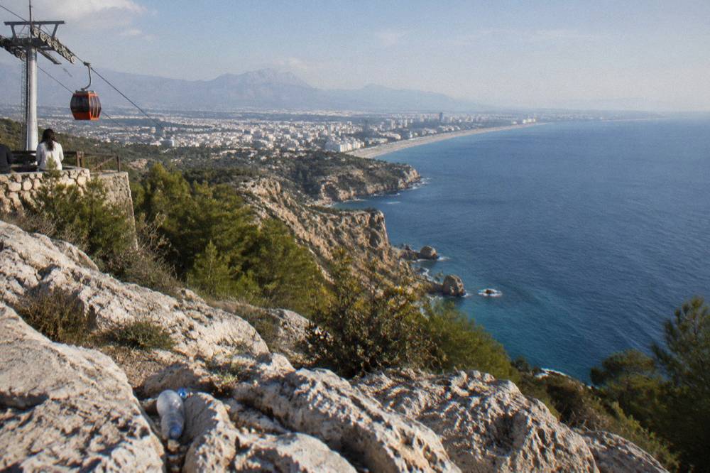 A hilltop terrace above the sea with a wide view along a rocky coastline