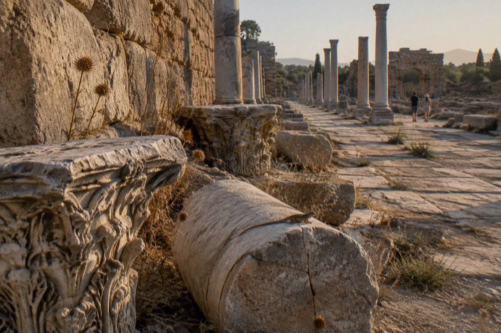 Ancient stone columns and ruined walls of Perge under open sky