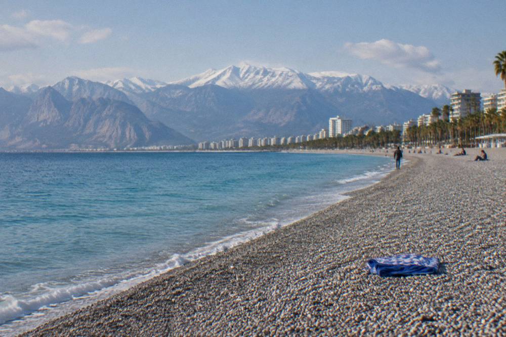 Konyaalti pebble beach with calm water along the shore