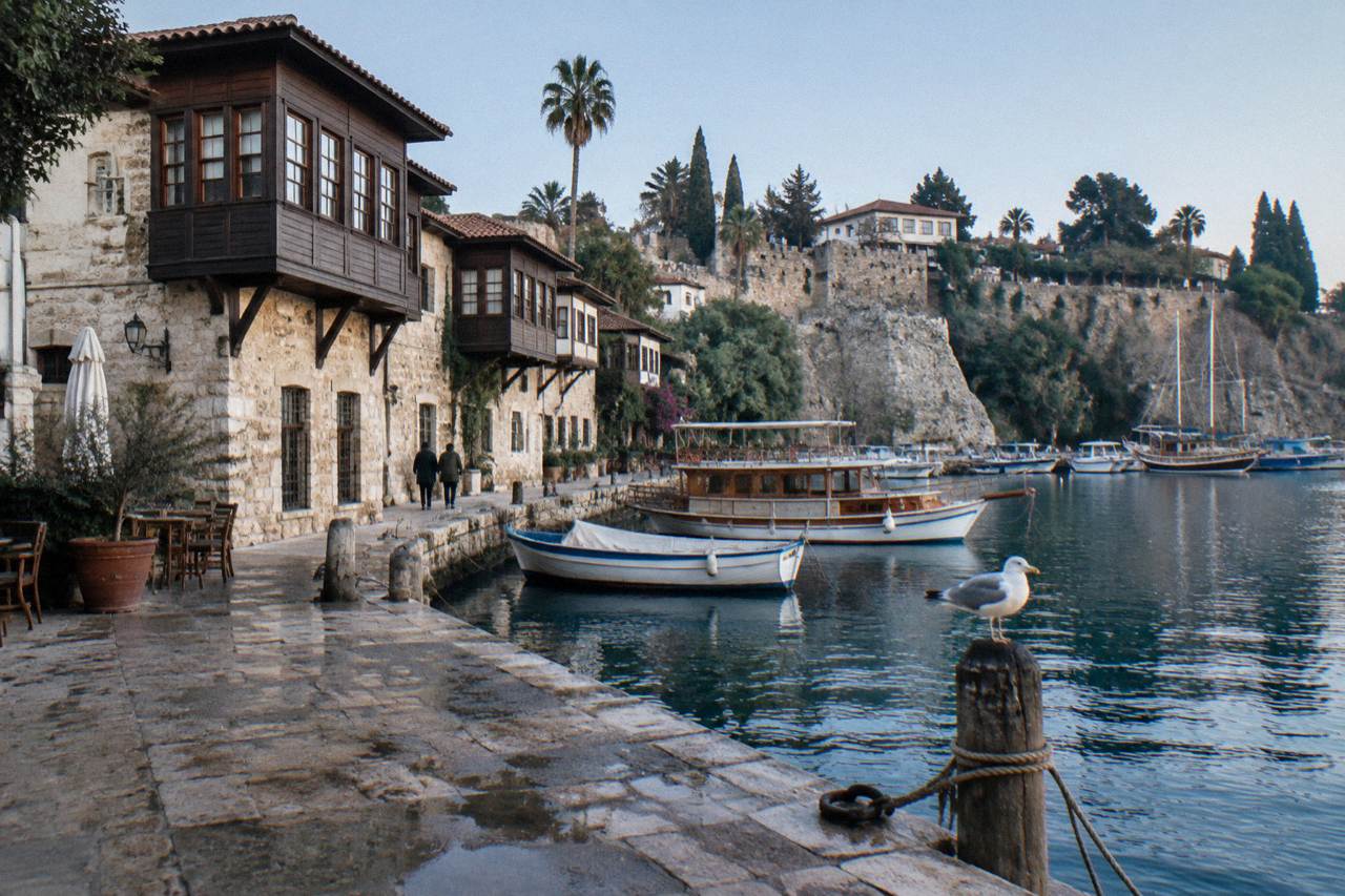 Kaleici old town stone buildings under a clear sky beside the harbour
