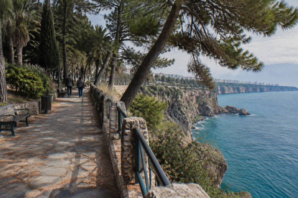 Clifftop park path above the sea with pine trees in Antalya