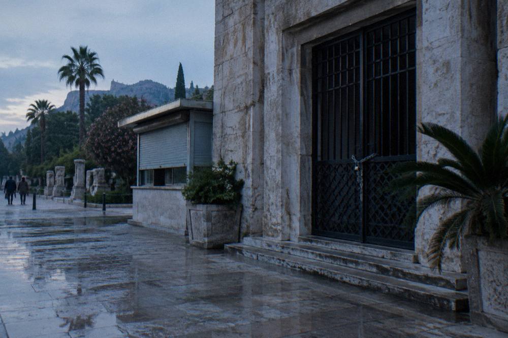 A shuttered museum entrance with a stone facade in Antalya
