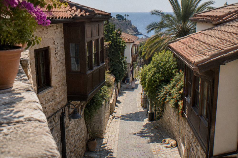 Narrow old town street with stone walls and wooden upper floors
