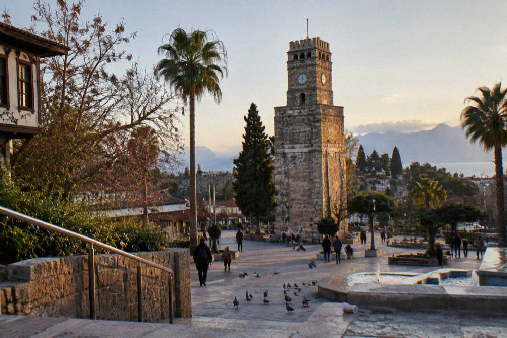 Stone clock tower standing above a city square