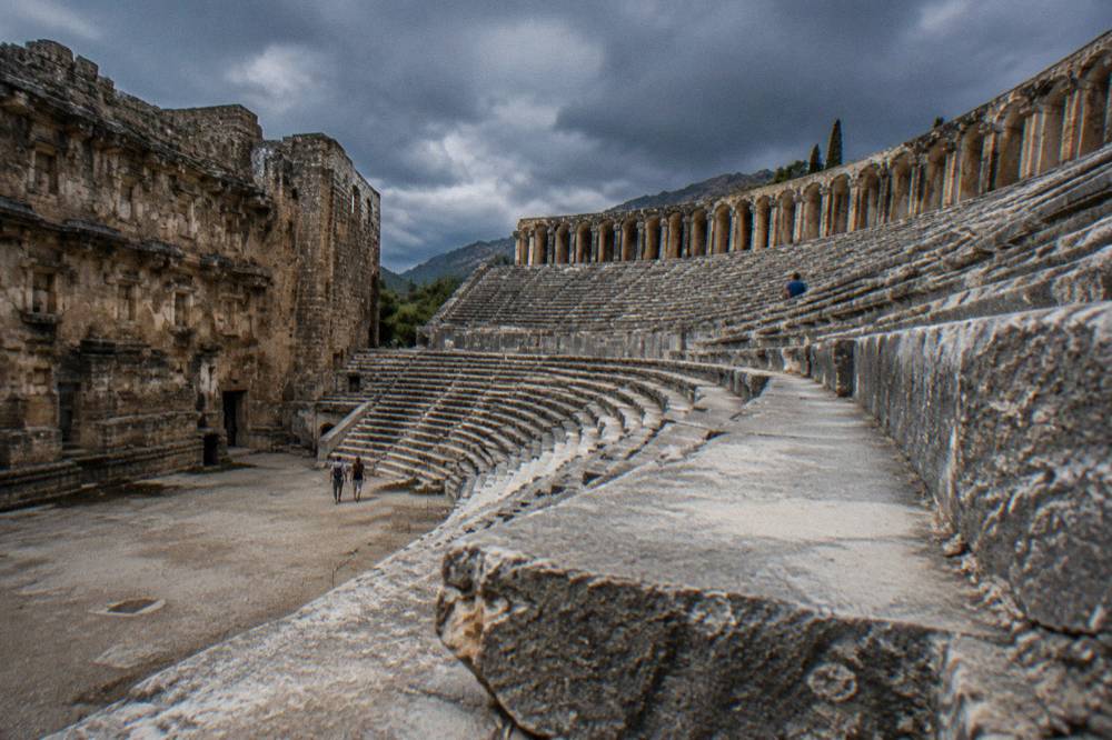 Rows of stone seats rising above the orchestra floor of the ancient theatre