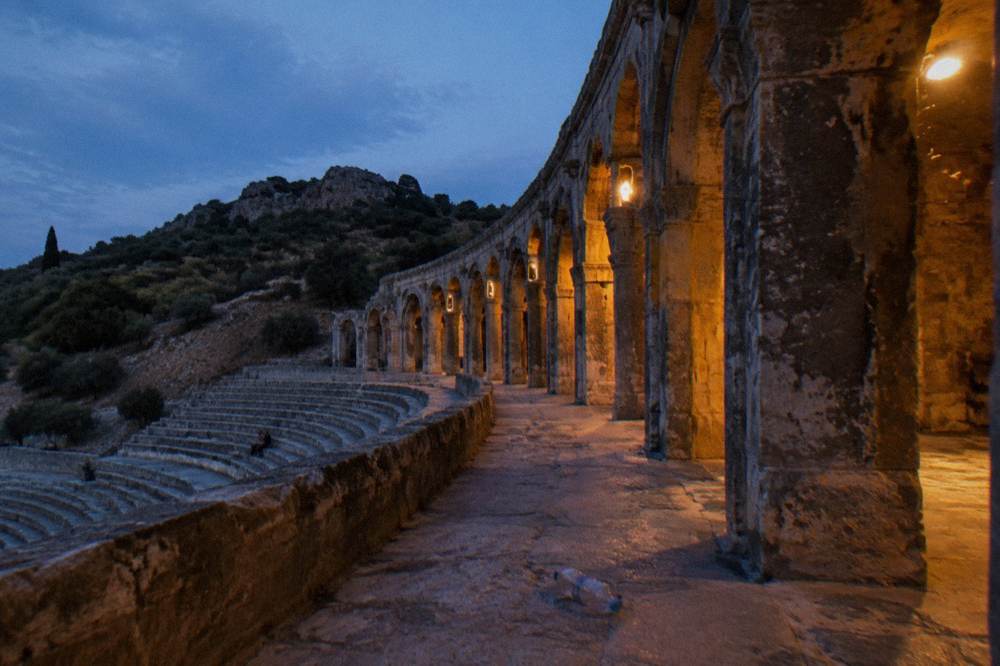 The arched gallery running along the top of the theatre seating at dusk