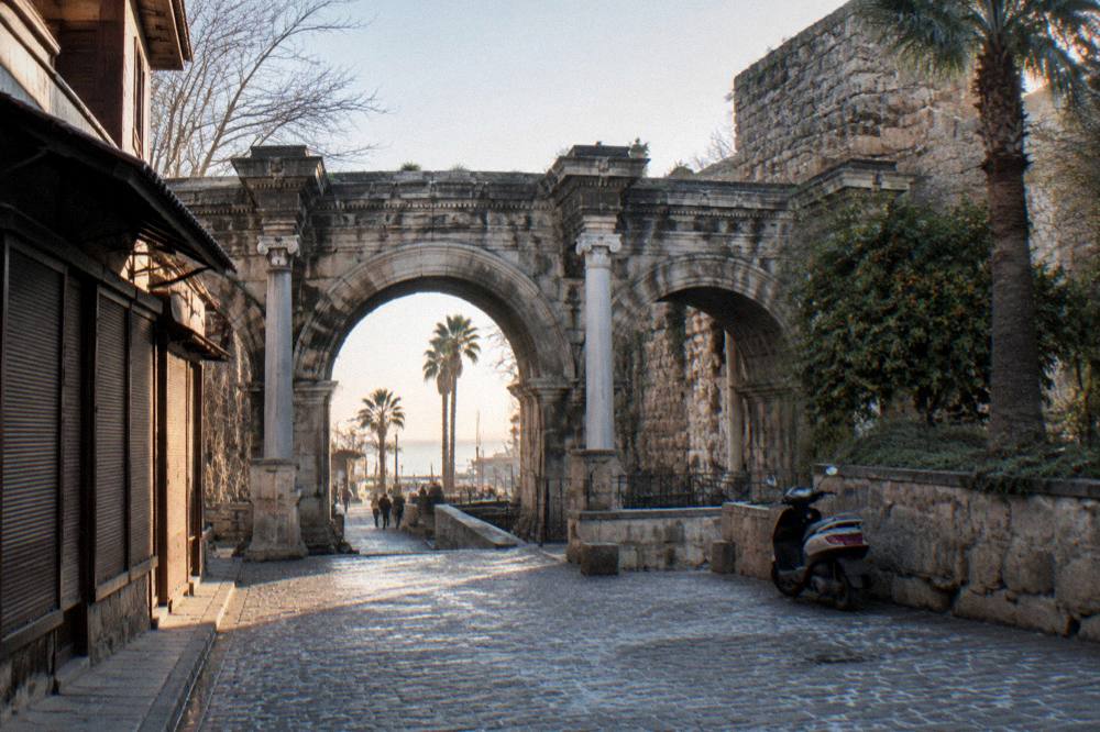 The arched Roman gate of Hadrian's Gate standing over the old town street