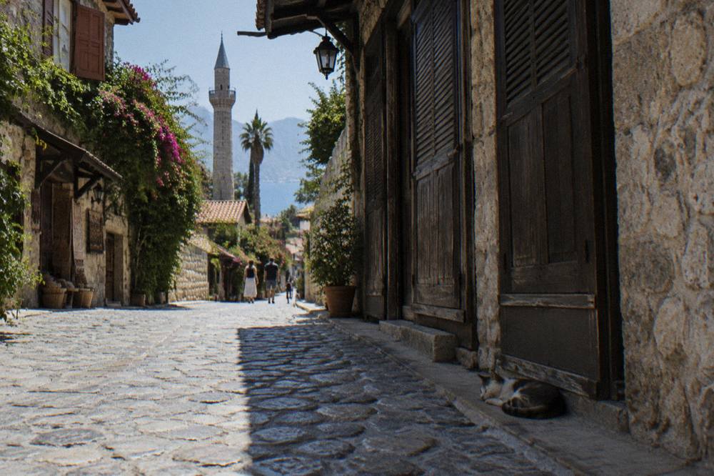 Narrow old town street in Kaleici with stone walls and shuttered shopfronts