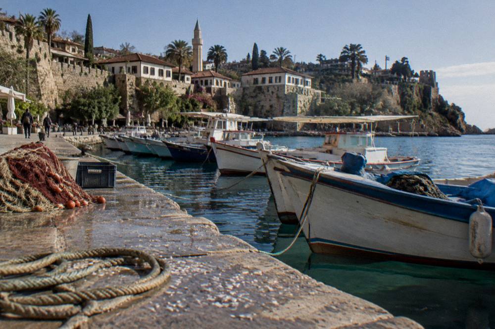 The old harbour quay in Kaleici with moored boats along the stone edge