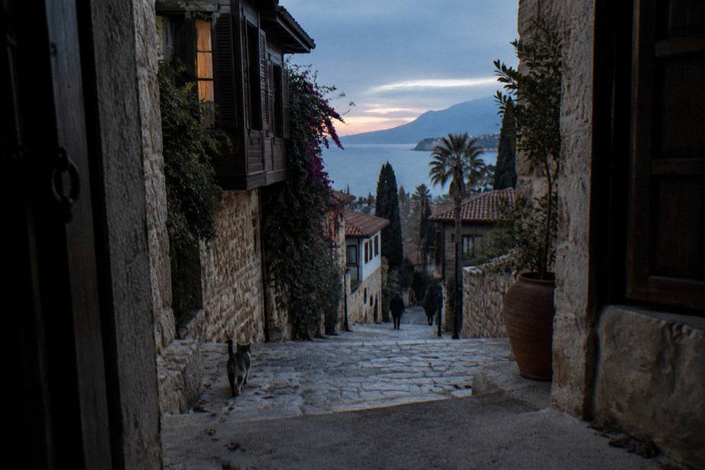 Narrow old town lanes with stone walls leading down through Kaleici