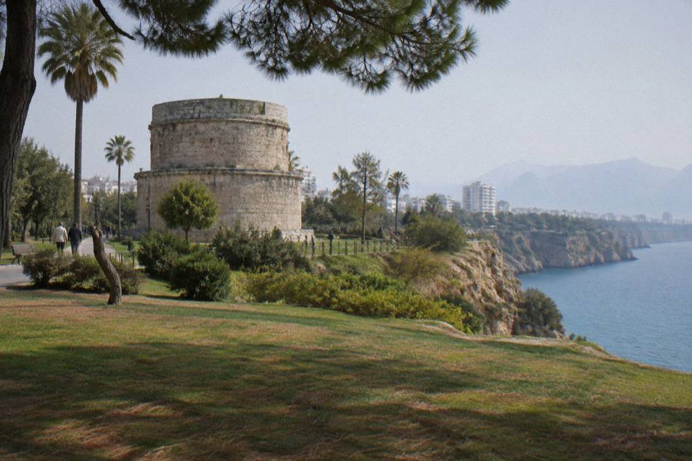 A stone tower standing in an open park above sea cliffs