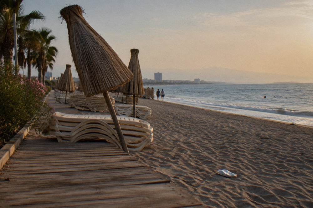 Beach club terrace with parasols and loungers facing the sea along the Lara coast