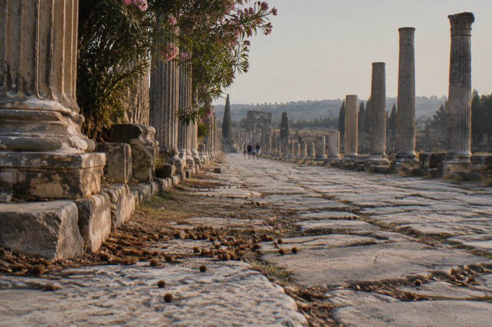 A long colonnaded ancient street lined with stone columns