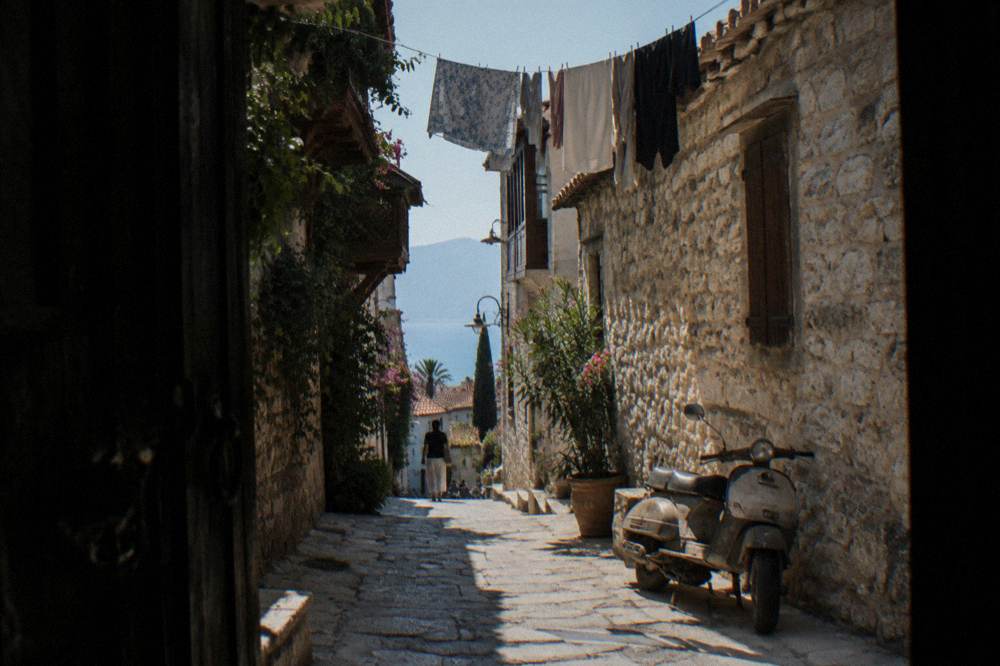 Narrow old town street with stone buildings in Antalya Kaleici